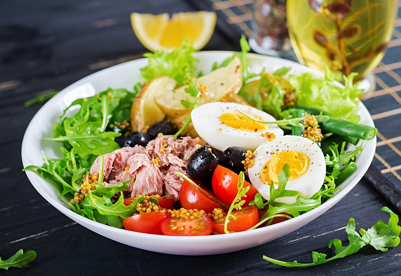 healthy-hearty-salad-tuna-green-beans-tomatoes-eggs-potatoes-black-olives-close-up-bowl-table